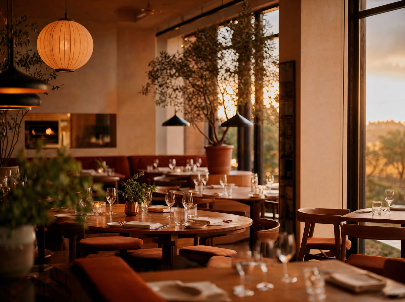 A warm, full-service restaurant dining room at golden hour